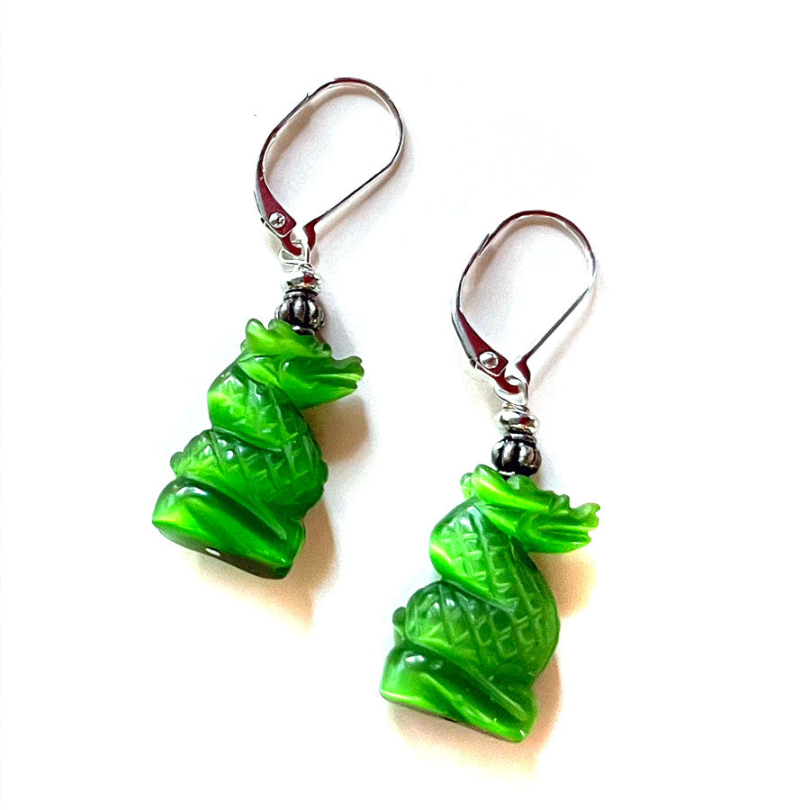 Close-up of Green Dragon Earrings with glowing emerald optic stones, ideal for dragon enthusiasts.