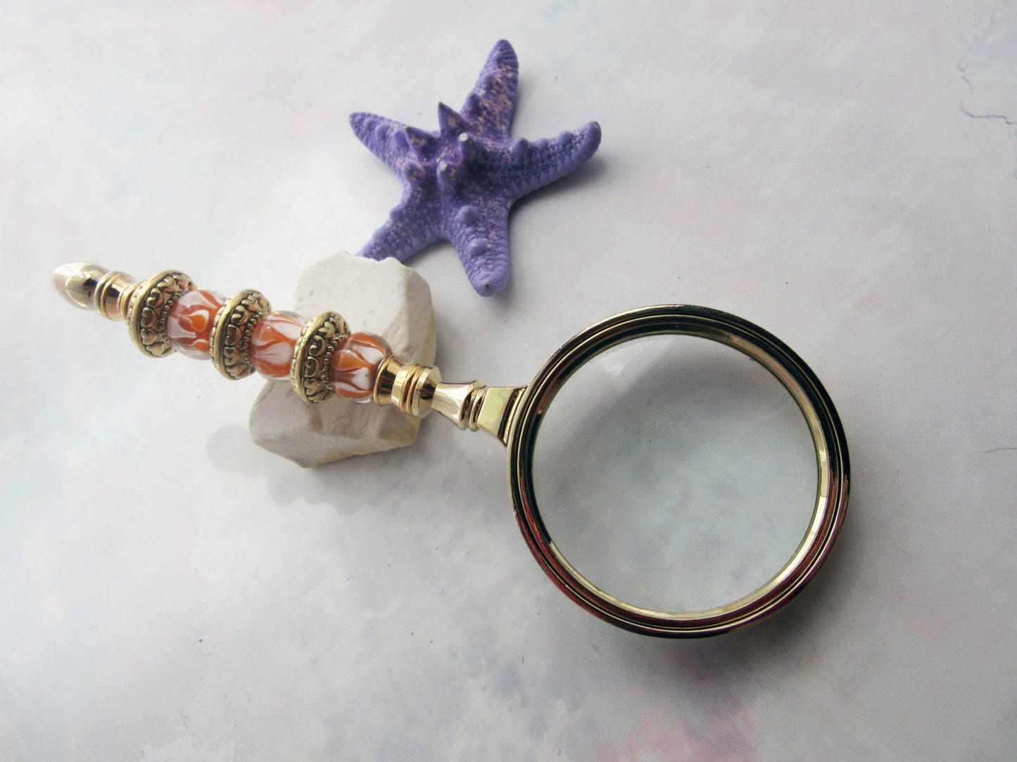 Golden Orange Bead Magnify Glass showcasing stunning sunburst orange beads and golden faceted glass, perfect gift for grandparent or Mom.