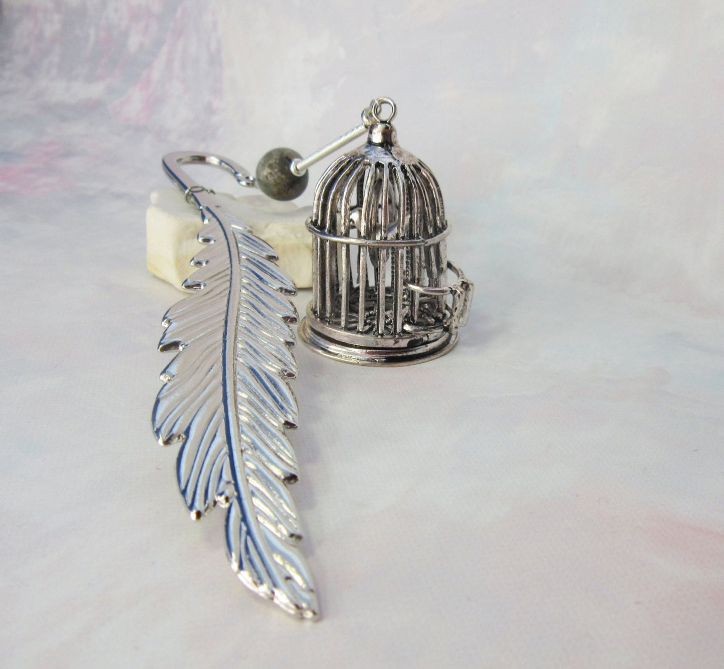 BIRD CAGE BOOKMARK - Detailed silver bird cage feather bookmark ideal for avid readers.