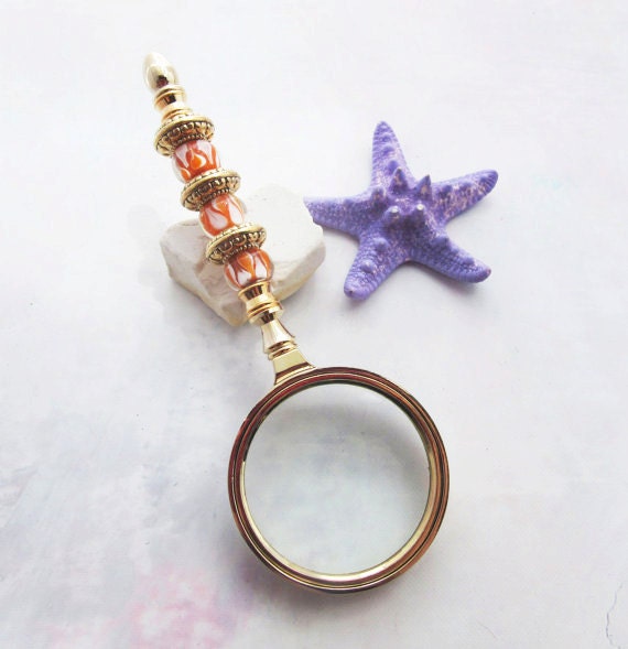Golden Orange Bead Magnify Glass - Close-up of the stunning orange beads and gold metal of this elegant magnifier, showcasing its artistic design and practicality for detailed viewing.