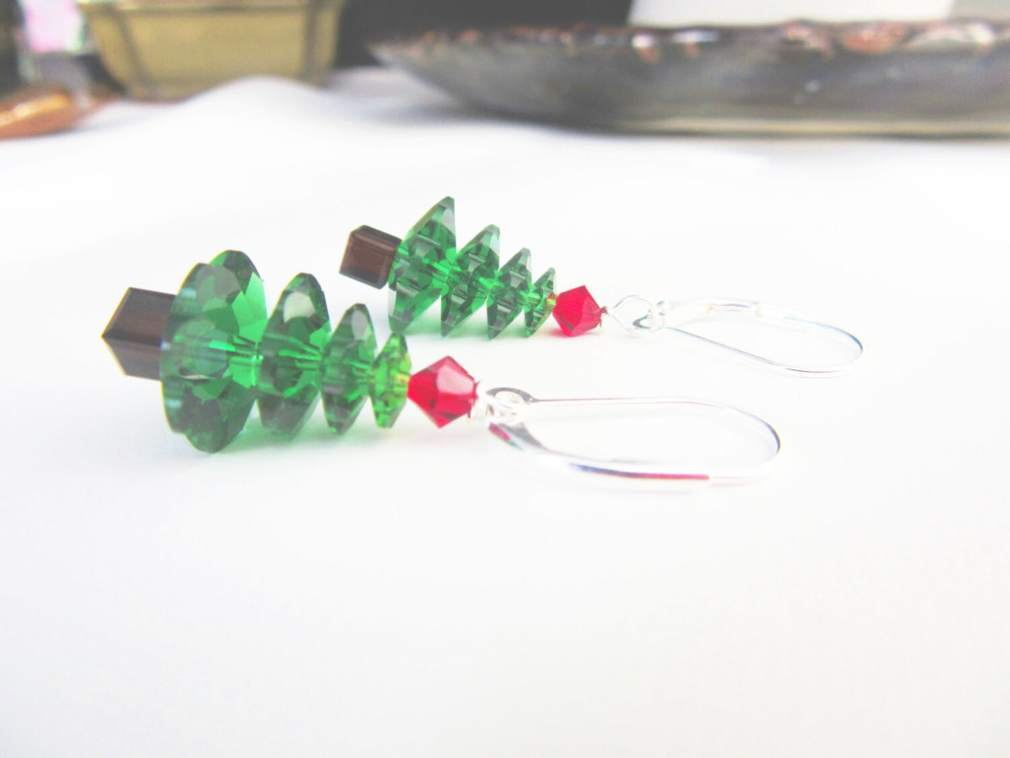 Close-up of Traditional Christmas Earrings showcasing detailed green crystal Christmas tree jewelry with silver lever-backs, ideal for festive occasions.
