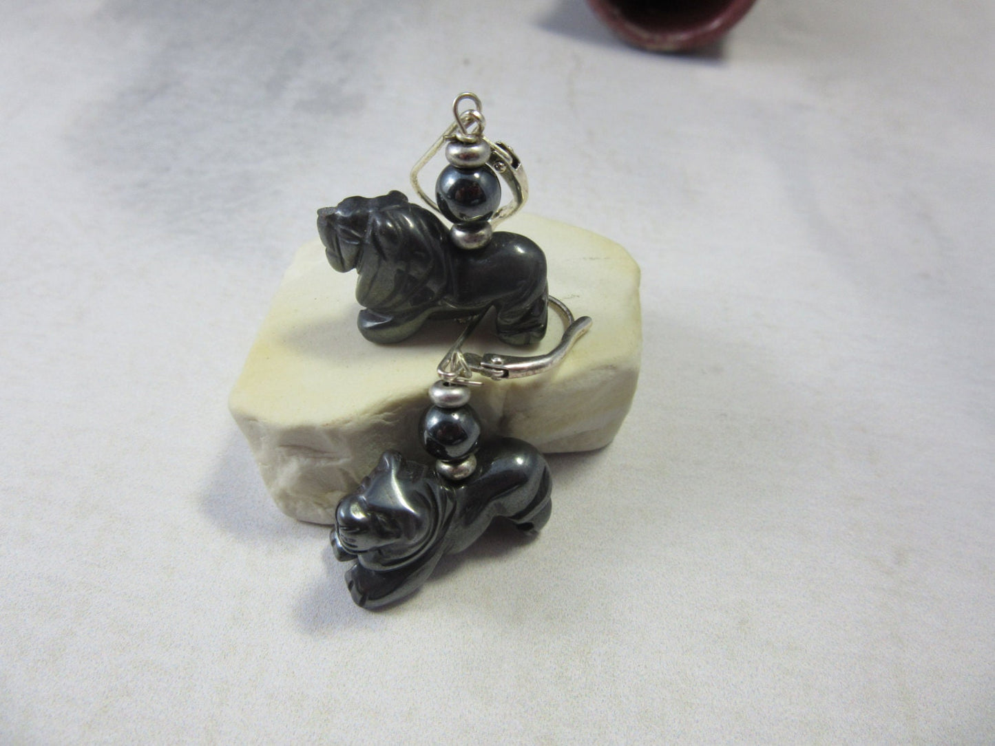 Lion Earrings made of carved hematite, showcasing intricate lion designs, ideal for animal lovers and safari guide gifts.