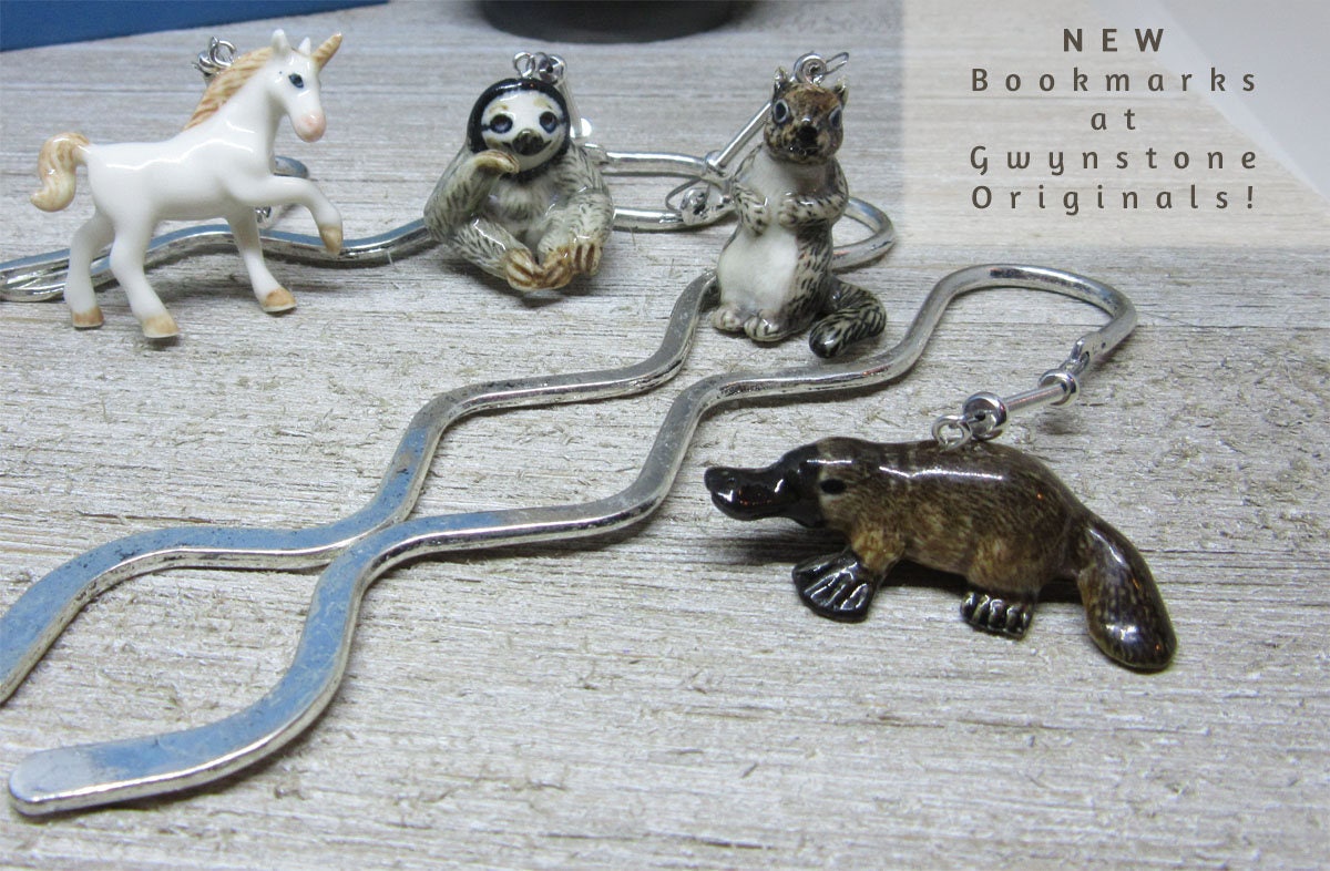 Silver squiggly bookmark with a green dragon for avid readers; a fun gift for anyone who loves fantasy.