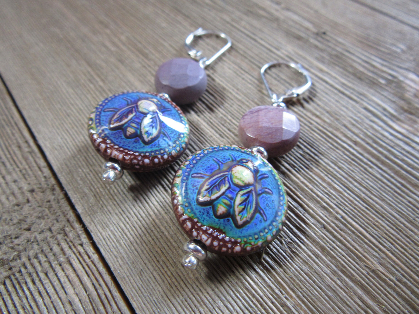 Bee Lover Jewelry Mood Bead Honeybee Earrings with Jasper Accent—handmade and perfect for any apiculturist, featuring blue and brown ceramic beads with leaf designs, faceted pink accents, and silver findings. A charming gift for bee fans!.