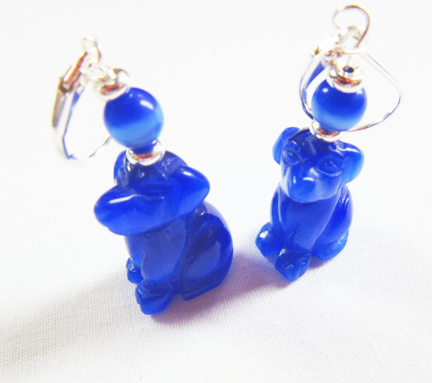Close-up view of Optic Blue Dog Earrings featuring shiny color and sterling silver lever back ear wires for dog lovers.