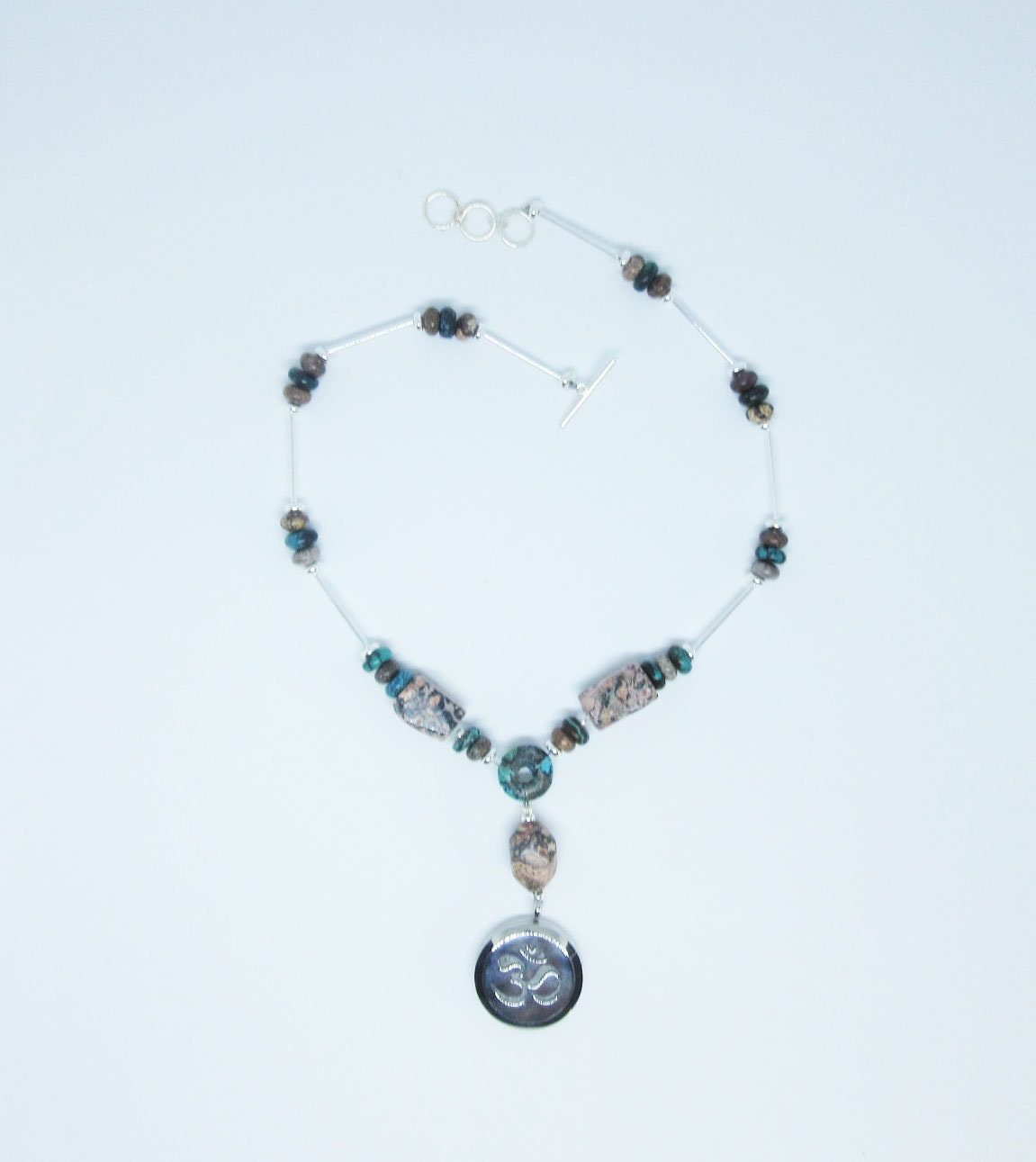 Artisan design rhodochrosite and turquoise essential oil diffuser necklace showcasing a calming Zen aesthetic, perfect for self-care gifts.