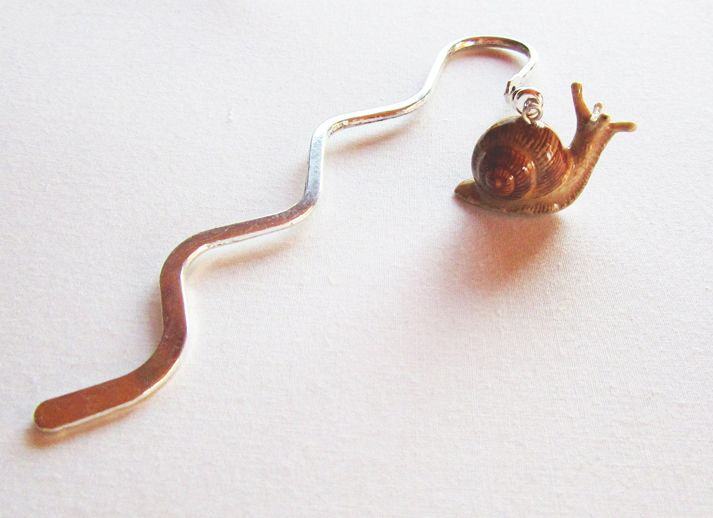 Snail bookmark - small figurine memento showcasing a cute snail design perfect for marking your place in a book.