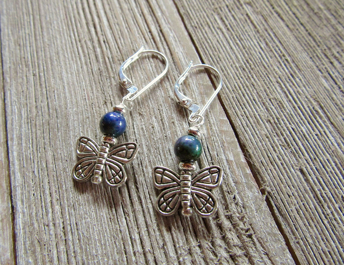 Butterfly Mood Bead Earrings: Color-Changing Animal Theme—silver earrings with blue and green accents, shown on rustic wood. Perfect for those who love animal jewelry that shifts color!.
