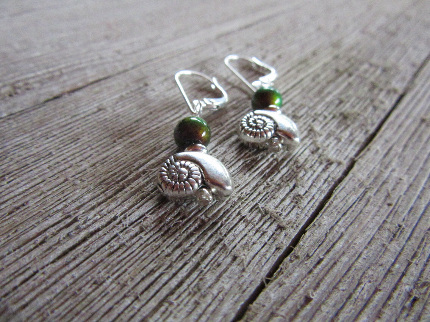 SEA SHELL EARRINGS - Display of elegant Silver Shell Earrings - Dangle style with vibrant color-changing beads, ideal for adding a touch of boho charm to any outfit.