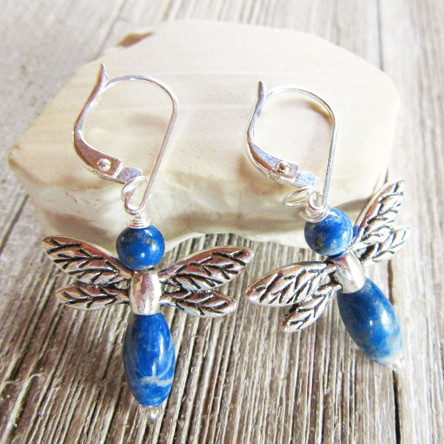 Artisan-made dragonfly earrings with blue sodalite stones, highlighting their healing properties and elegance.
