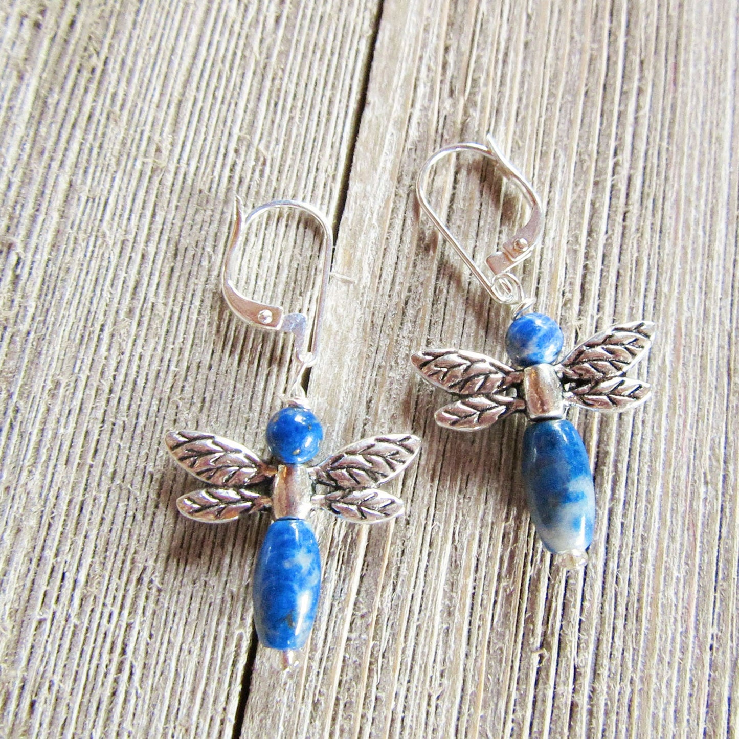 Close-up of blue sodalite dragonflies earrings, showcasing carved stone design and unique charm.