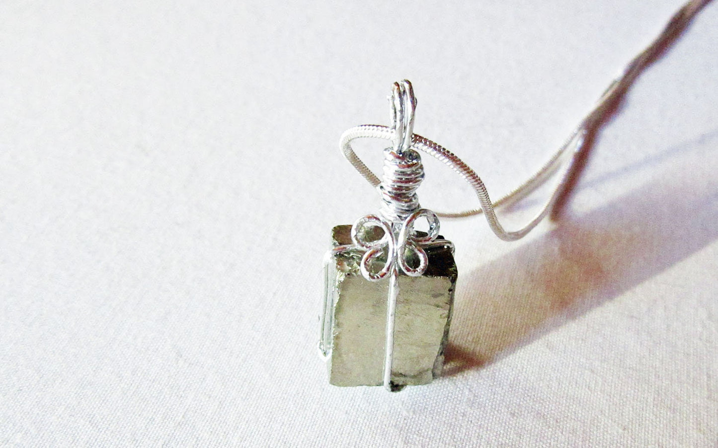 Stylish model wearing the Pyrite Crystal Pendant - Chunky Gold Necklace, illustrating how it complements outfits while promoting well-being and inner peace.