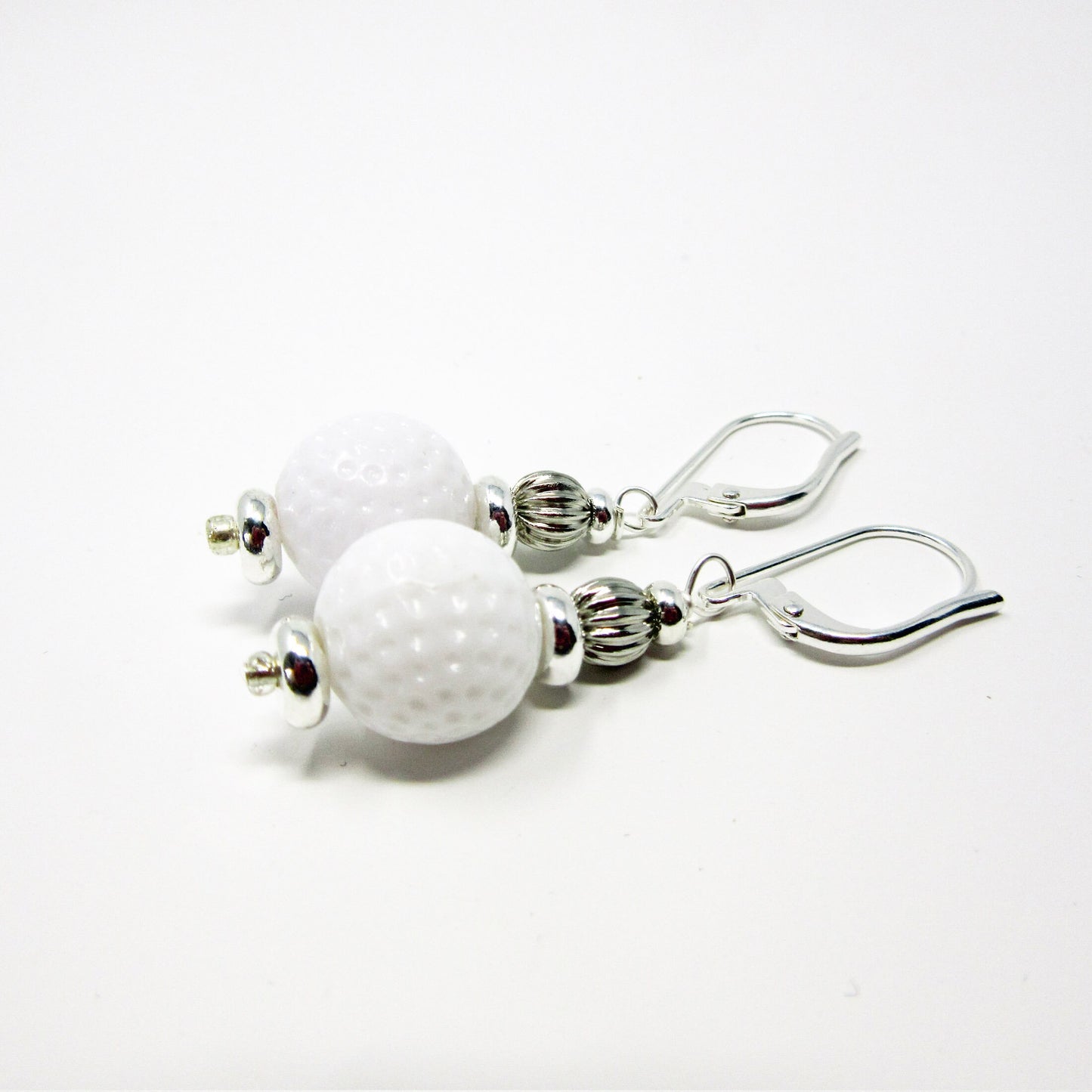 Golf Earrings a Gift for Woman Golfer set against a rustic backdrop, emphasizing the unique handmade quality.