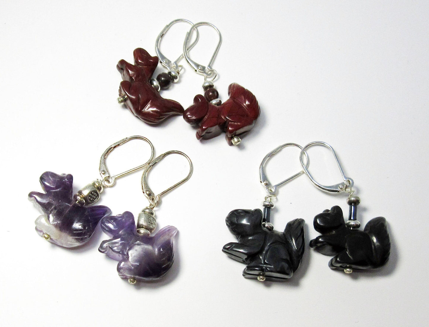 Close-up of Squirrel Earrings showcasing intricate carvings in hematite, perfect for quirky, nature-loving friends.