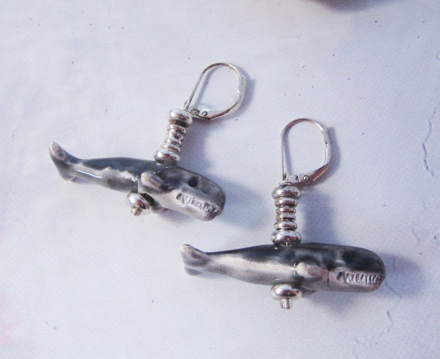Close-up of hand-painted Sperm Whale Earrings, exotic animal gift perfect for sea animal science enthusiasts.
