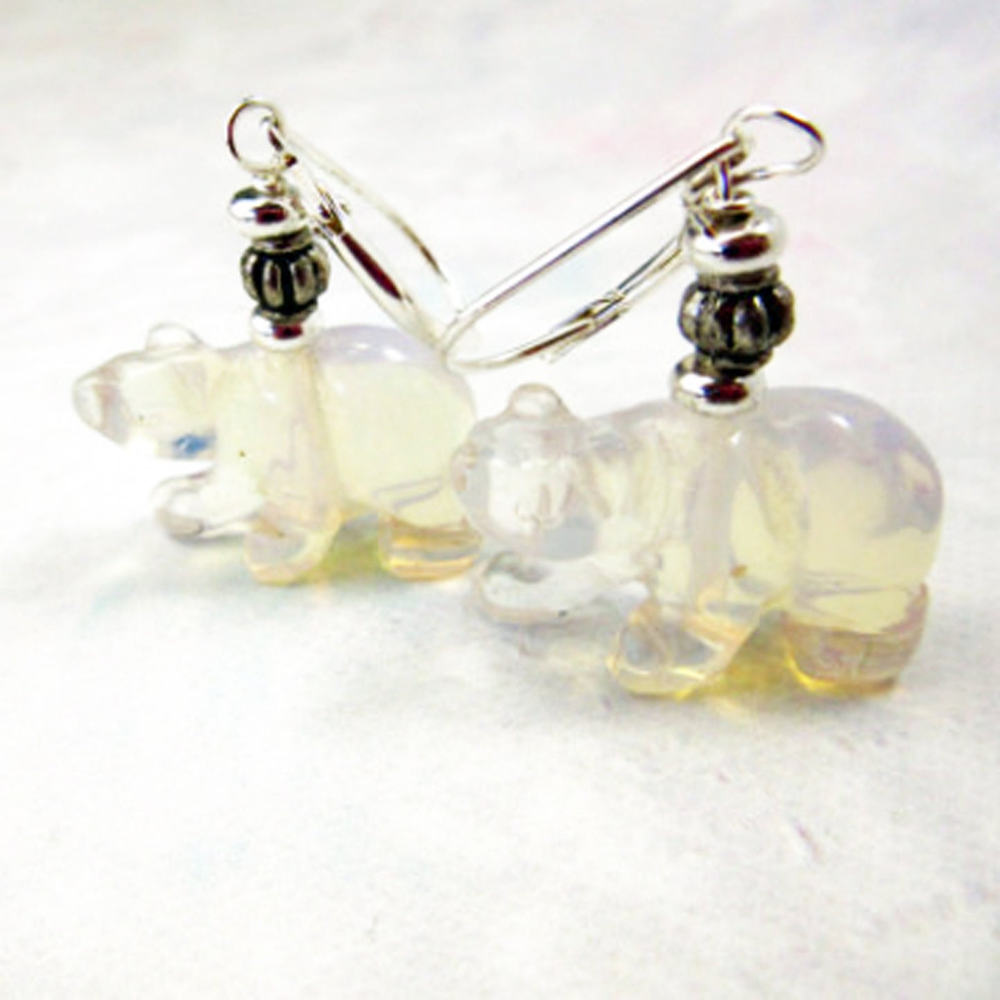 White Bear Earrings featuring hand-carved stone design for polar wildlife lovers, made with moonstone and clear quartz, from Enlivenadorn by Gwynstone.