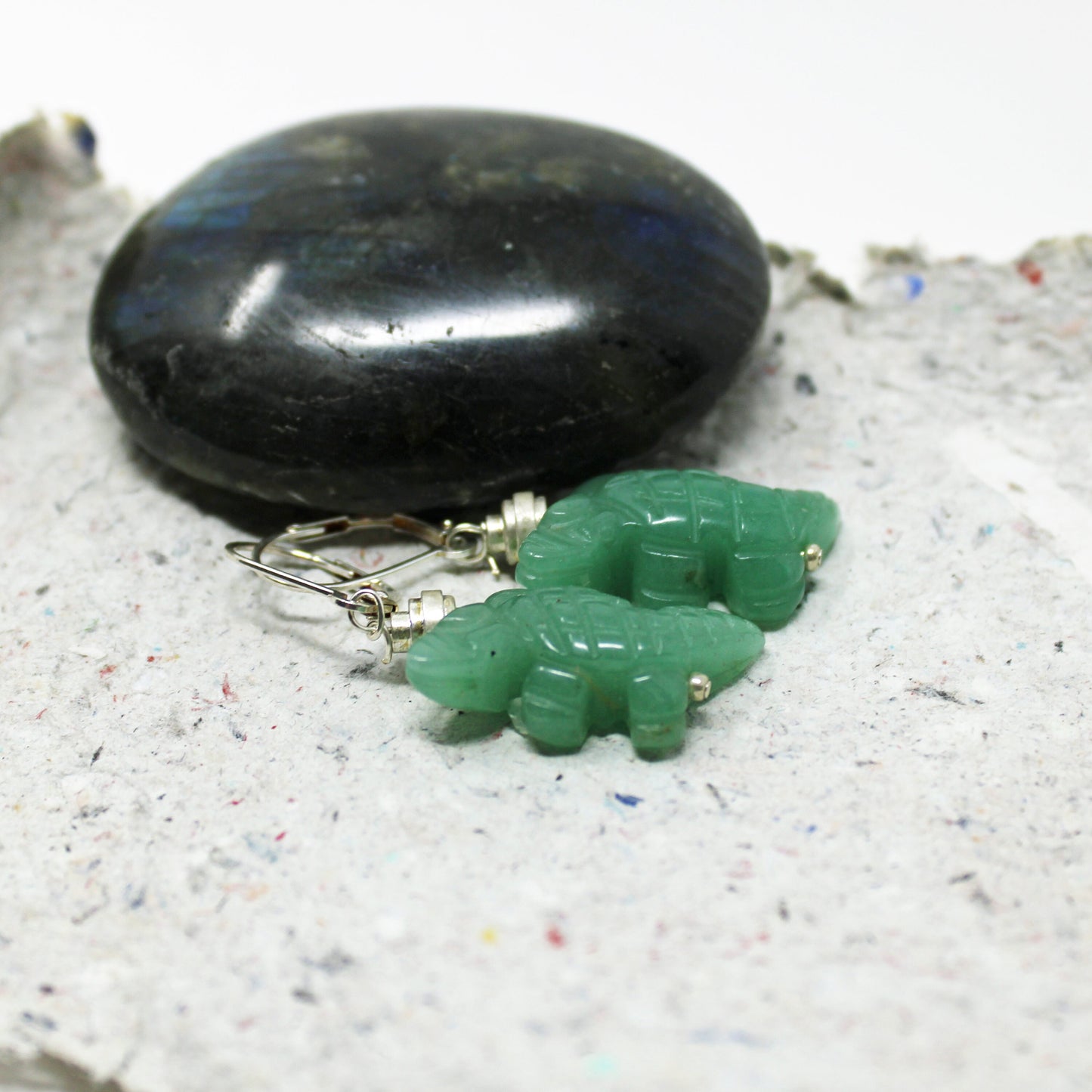 Close-up view of carved aventurine lizard earrings, perfect gift for lizard lovers.
