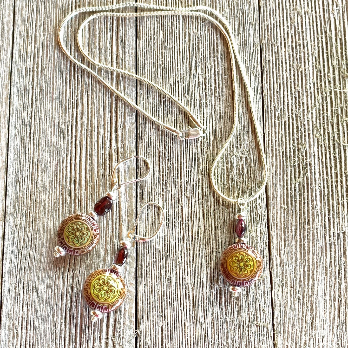 Close-up of the elegant Magic Mandala and Garnet earrings, showcasing the intricate design and mood-changing bead, ideal for healing and meditation.