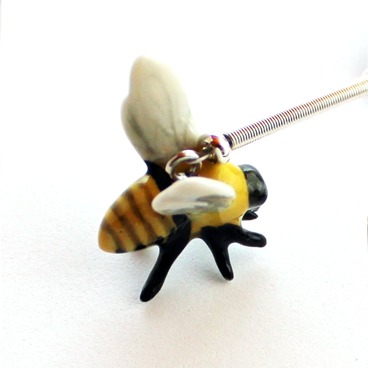 Buzzing Bee Porcelain Bookmark with intricate honeybee design on a bronze floral base, perfect gift for bee lovers and apiculturists.