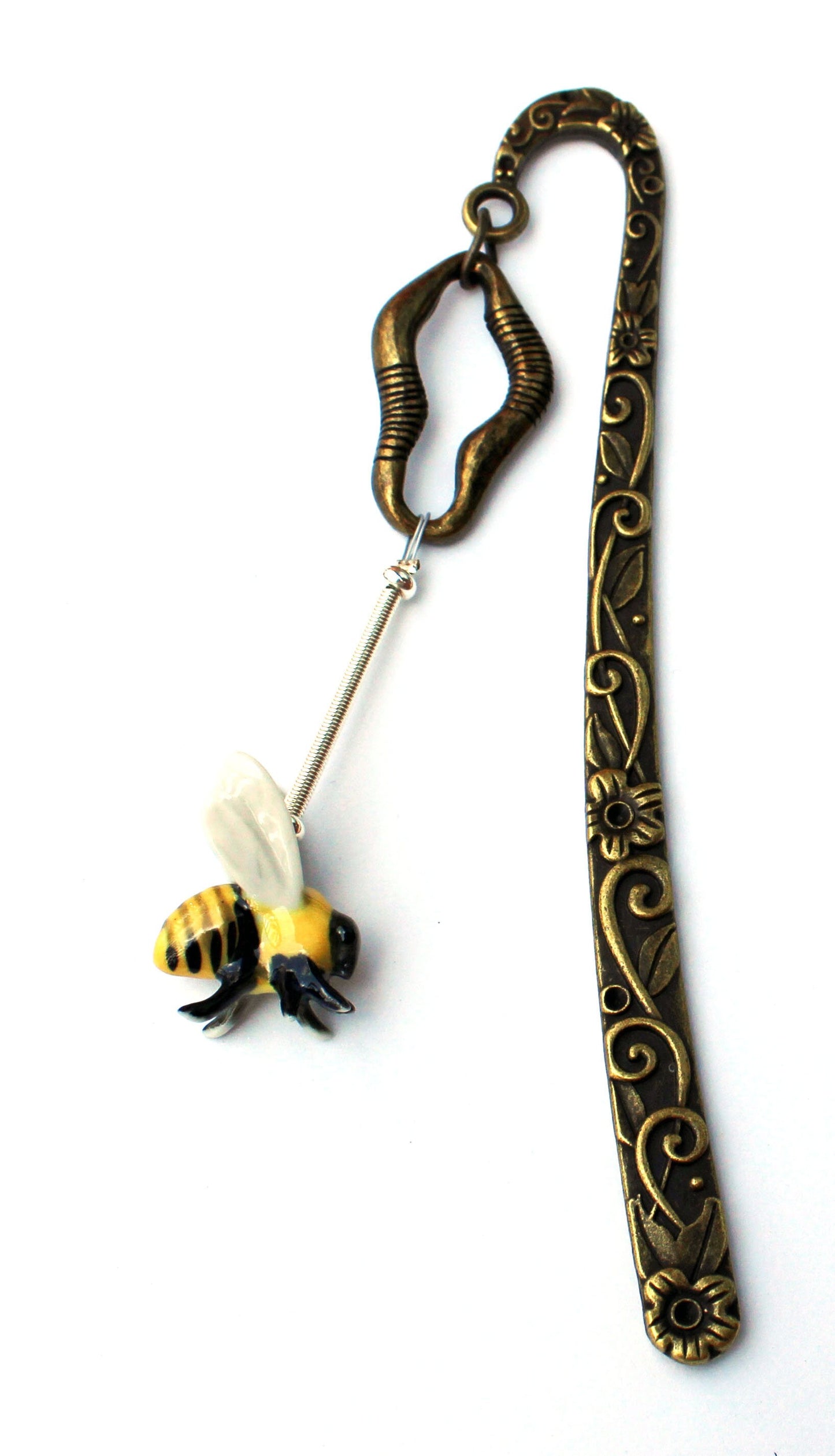 Buzzing Bee Porcelain Bookmark displayed among books, highlighting its decorative role as a place marker for readers and gift for bee lovers.