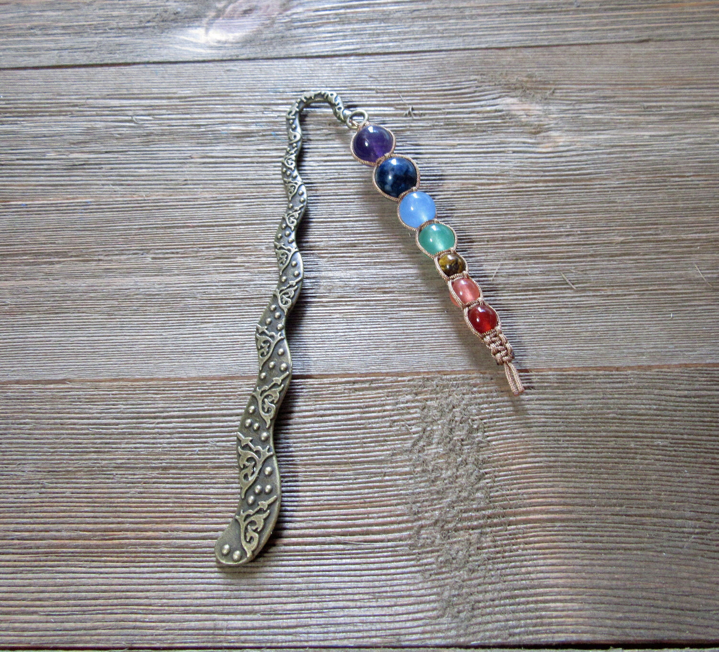 Beautifully designed chakra metal bookmark, a spiritual gift for avid readers, featuring seven chakra beads to promote balance and energy.