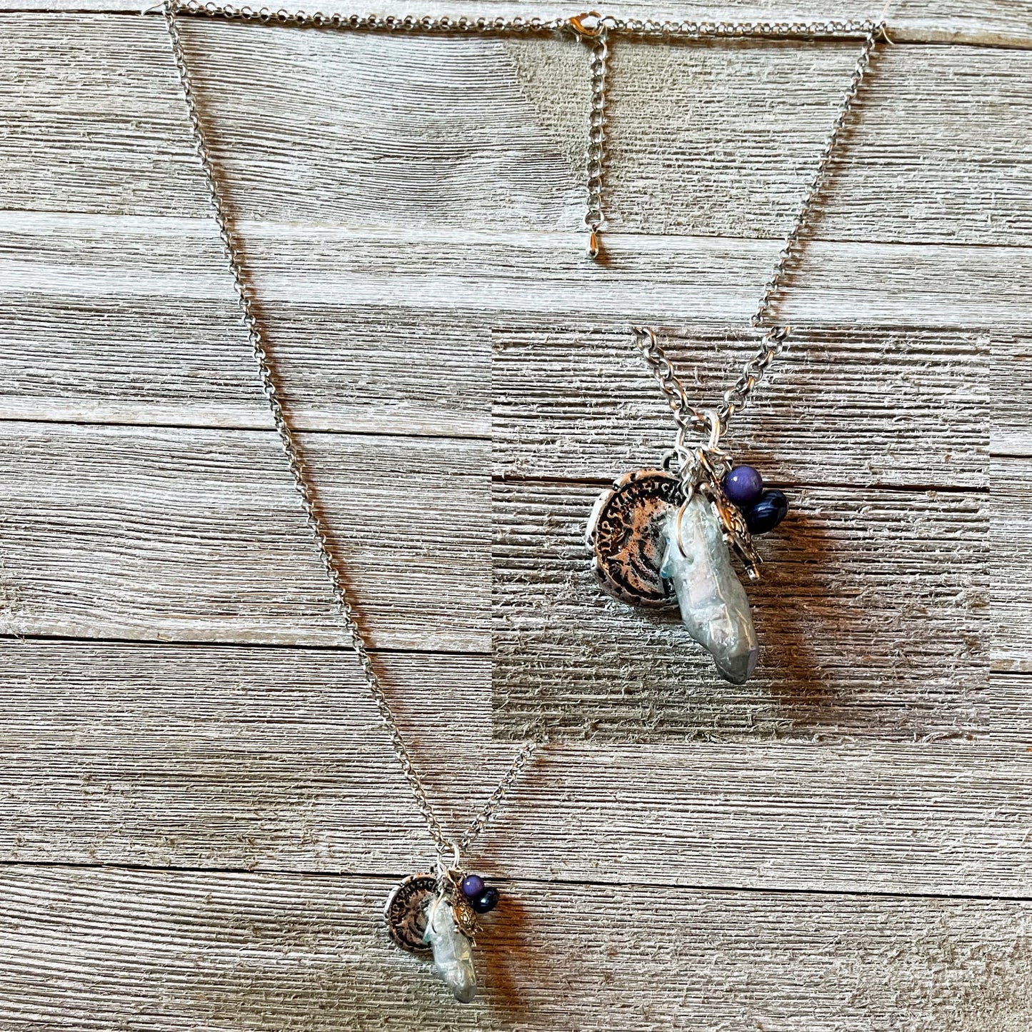 Close-up of the Pirate’s Booty Charm Necklace showcasing its shimmering silver design and unique nautical treasures.