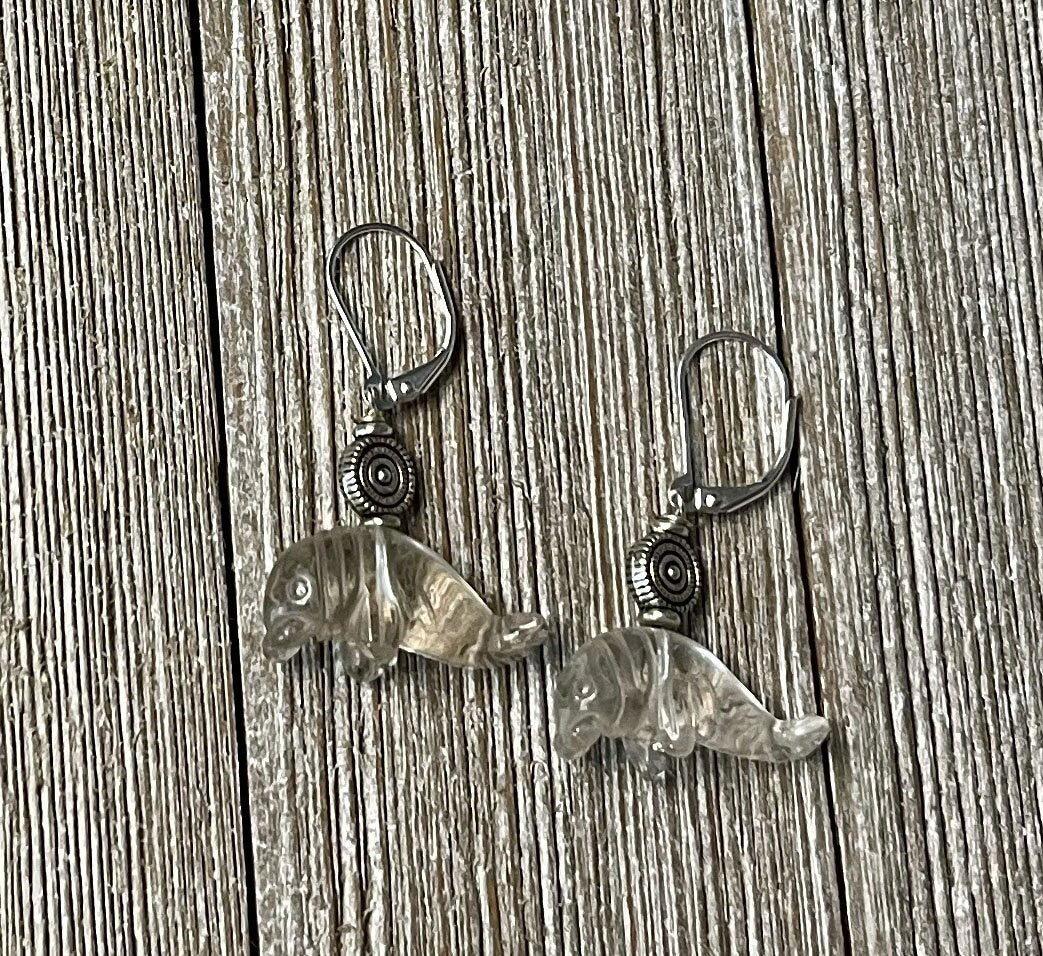 Manatee Earrings featuring clear quartz drop design, carved stone manatee jewelry, perfect ocean-themed gift for ocean lovers.