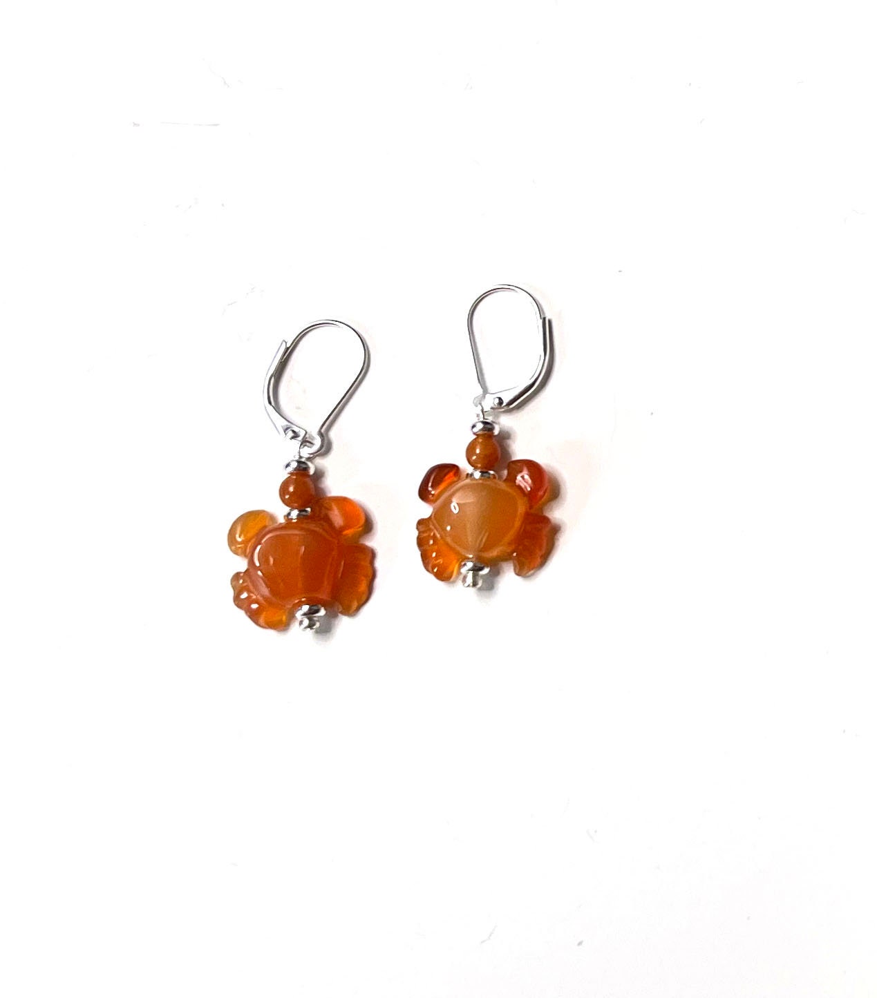 Model wearing Handmade Carnelian Crab Earrings, beautifully carved and unique stone dangle earrings, ideal gift for ocean enthusiasts.
