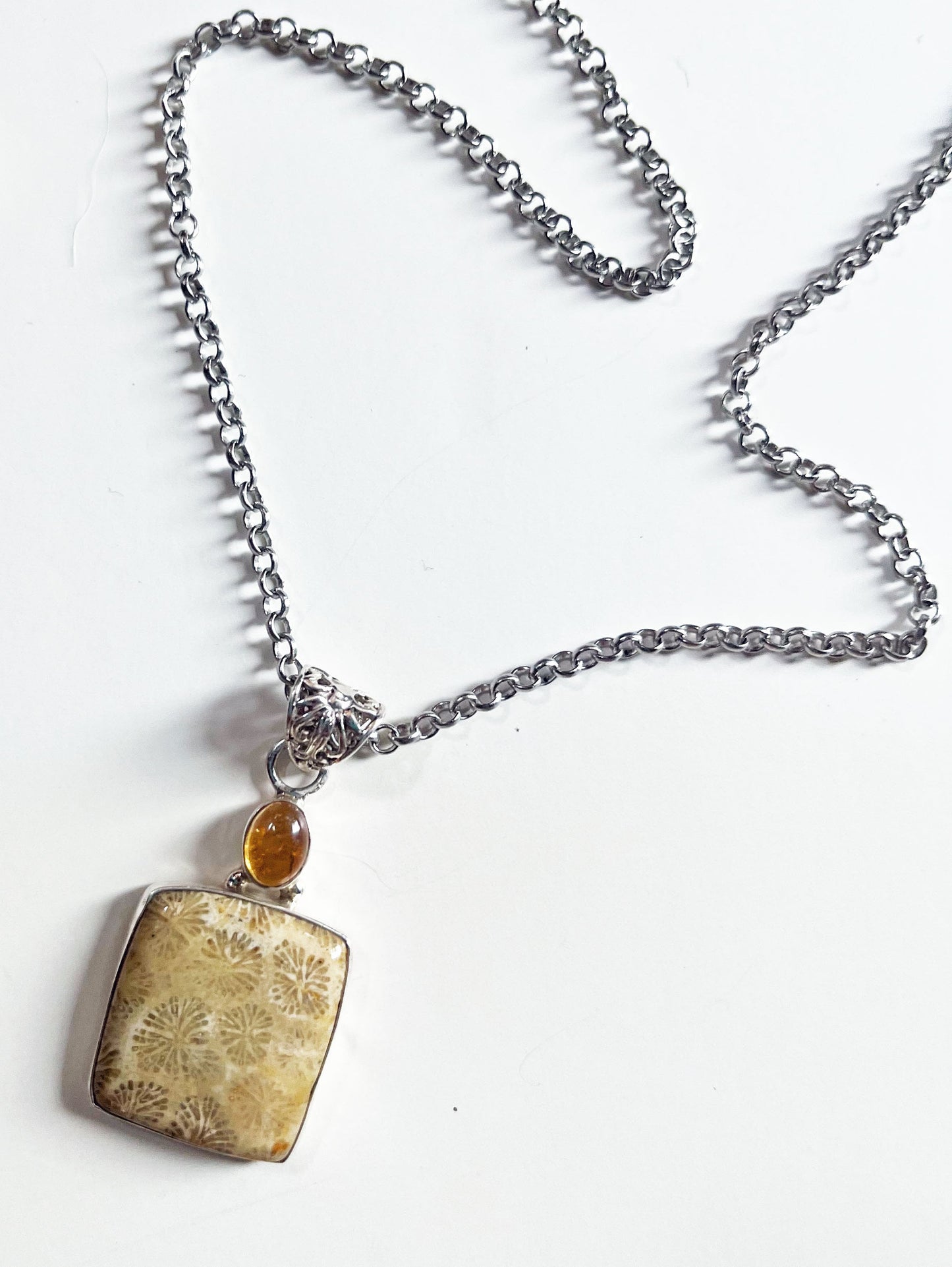 Close-up view of the Fossil Coral Jewelry Set with Topaz Topper, showcasing the unique fossilized coral stones and sterling silver lever back earrings.