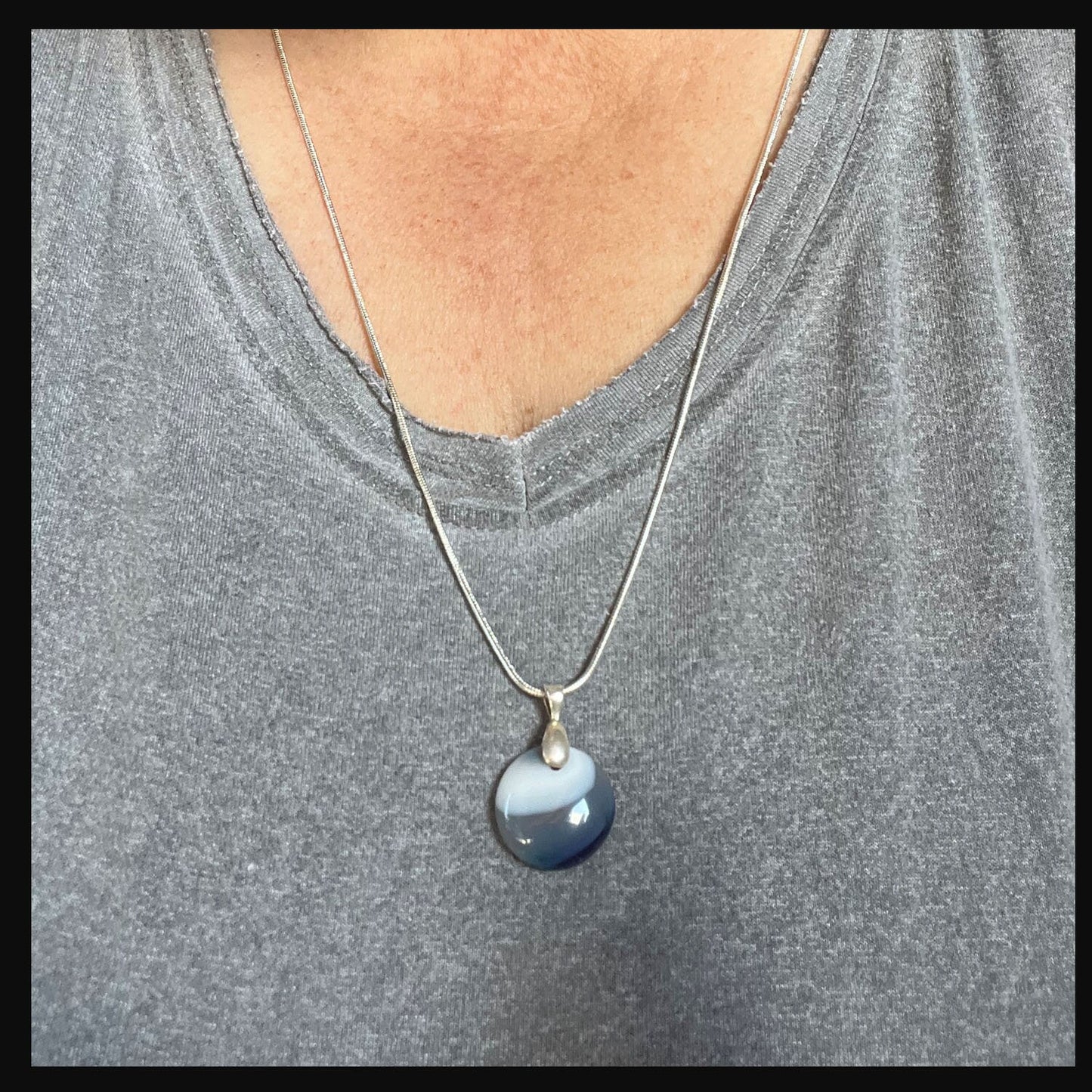 Close-up of Blue Agate Pendant Minimalist Necklace featuring an eye motif, highlighting its calming zen aesthetic.