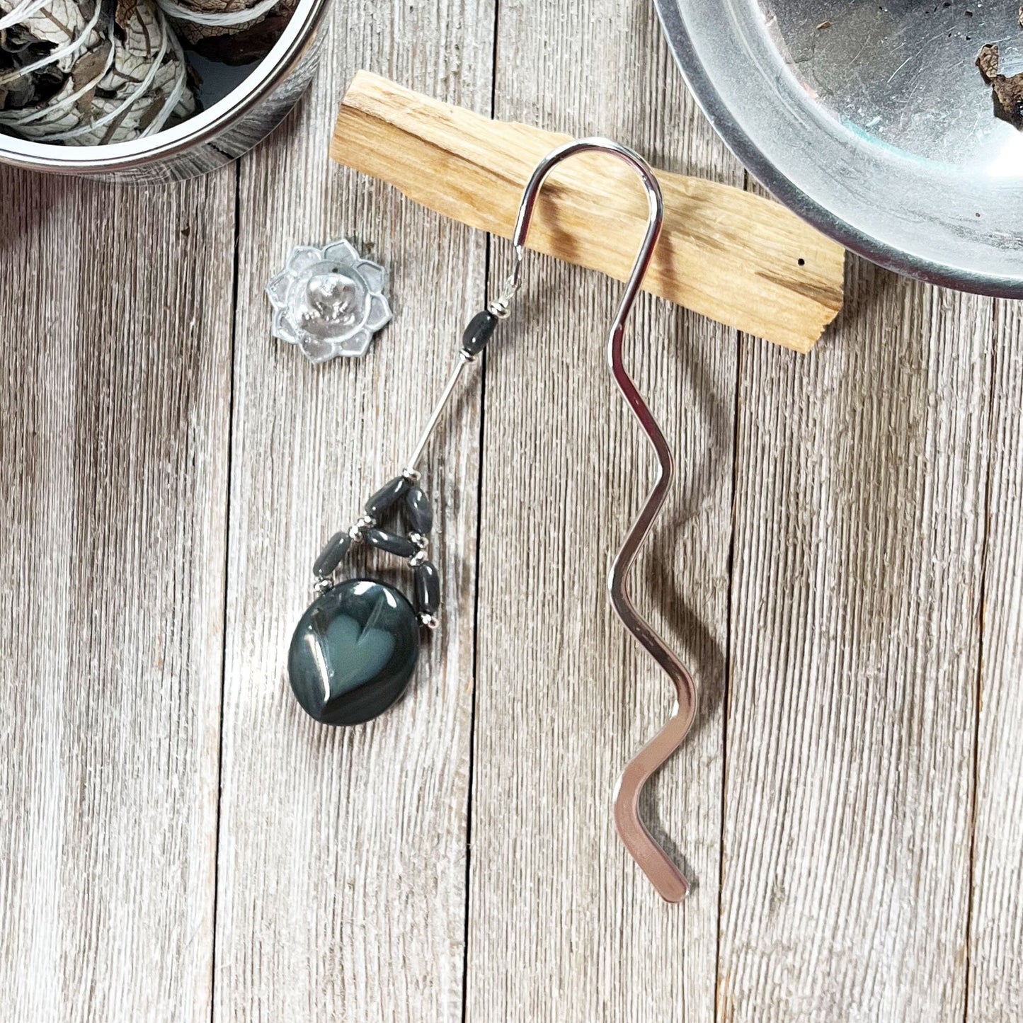Metal Bookmark Black Heart Stone Dangle featuring a beautiful stone entwined with labradorite, perfect as a gift for a Wiccan or witch.