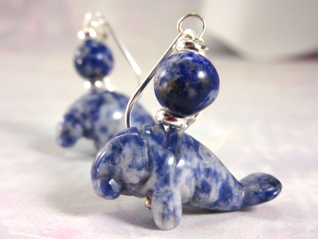 Close-up of Handmade Sodalite Manatee Leverback Earrings, showcasing blue and white marbled manatee charms with round sodalite beads, set on silver leverbacks—ideal Ocean Lover Jewelry against a soft, pale background.