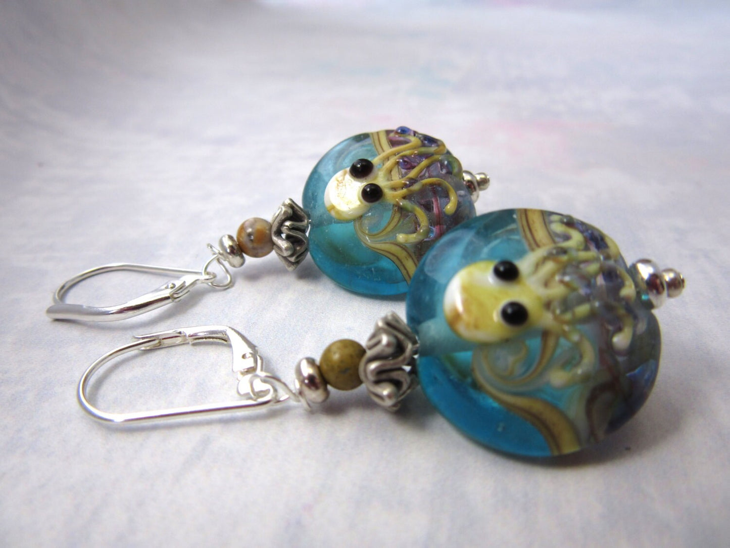 Close-up of Octopus Earrings showcasing intricate details of the lamp-worked glass octopi and googly eyes, perfect for ocean-themed jewelry collections.