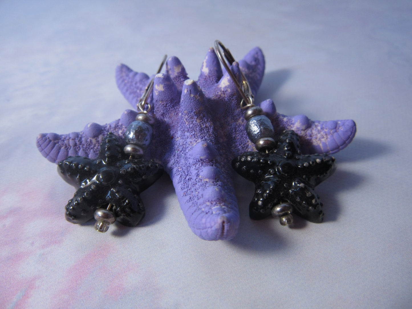 STARFISH SEA EARRING - Stylish drop earrings featuring black ceramic starfish and a beautiful freshwater pearl, ideal for boho style.