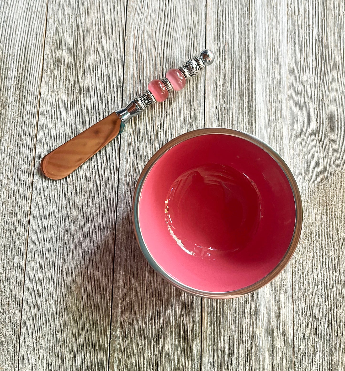 Dip Knife and Small Pink and Stainless Steel Bowl Tableware Combo - Close-up view of pink handled dip knife with a shiny stainless steel blade and decorative small silver bowl.