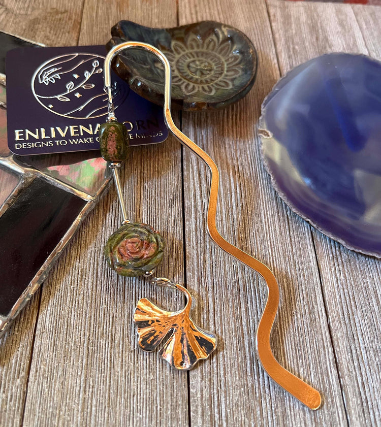 Bespoke Bookmarks collection featuring unique handcrafted designs including a metal raven bookmark, a whimsical fish stringer dangle, and elegant art glass bookmarks, perfect gifts for book lovers.