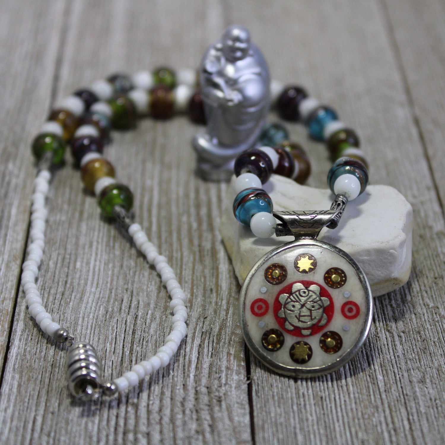 Meaningful Symbols collection featuring a stunning spiritual necklace with a detailed pendant showcasing artistic craftsmanship, surrounded by colorful beads symbolizing empowerment and self-expression.