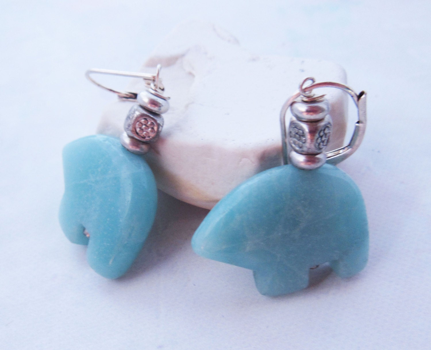 Handcrafted Amazonite Bear Earrings feature turquoise bear-shaped stones and silver bead accents, inspired by Sterling Silver Zuni Jewelry, and are displayed against a light background.