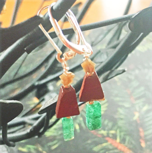 Minimalist Jasper Christmas Tree Earrings – Sterling Silver Holiday Jewelry with red triangle beads, gold star and green rectangle beads on gold hooks, displayed on a dark background with pine branches.