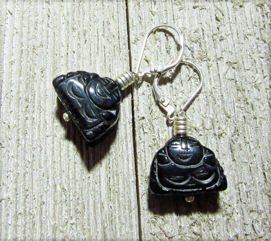 Handcrafted Black Onyx Buddha Earrings: Zen Jewelry Gift with carved Buddha charms and silver hooks, displayed on textured wood—ideal for a tranquil, stylish look.