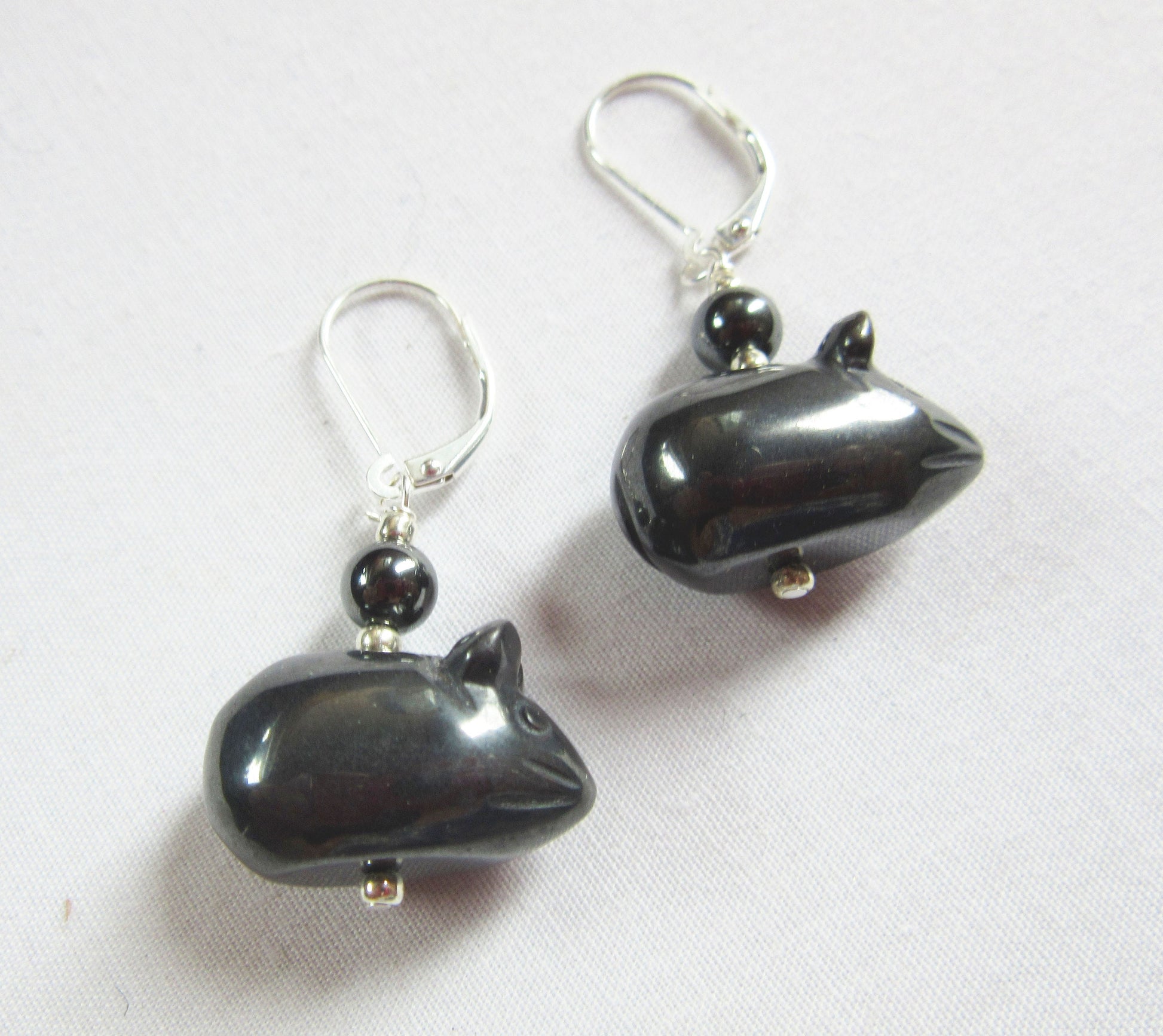 Hematite Mouse Earrings: Sterling silver hooks, shiny black hematite beads shaped like whimsical mice, and a round accent bead above each charm are displayed on a light background.