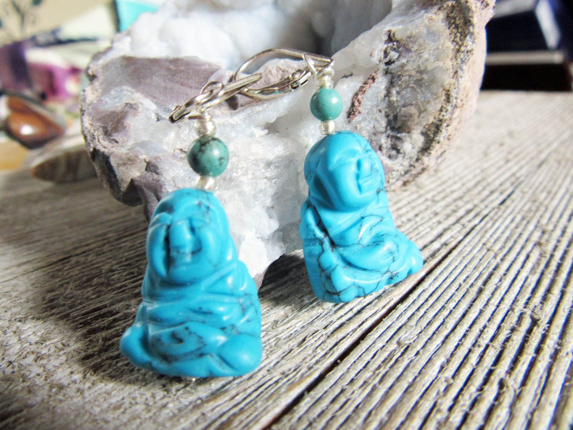 The Turquoise Blue howlite Buddha Earrings—Zen Jewelry for calming and happiness—feature turquoise beads and radiate peaceful energy, making them a unique accessory for tranquility seekers.