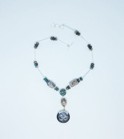 Artisan design rhodochrosite and turquoise essential oil diffuser necklace showcasing a calming Zen aesthetic, perfect for self-care gifts.