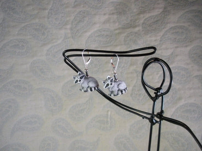 Raccoon earrings featuring hematite stone, handcrafted woodland animal jewelry for nature lovers, cute boho drop earrings.