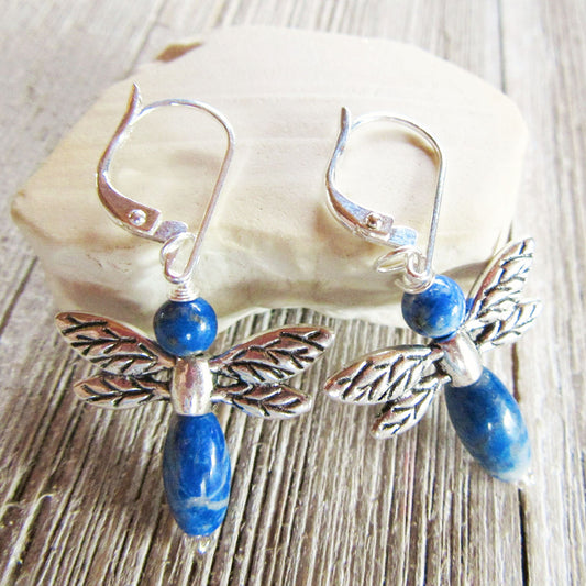 Sodalite Dragonfly Earrings by Gwynstone—handmade nature-inspired jewelry featuring blue stone beads, perfect as a gift for gardeners and wildlife lovers, shown on a light stone surface with a wooden background.