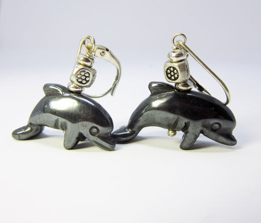 Handcrafted Hematite Dolphin Earrings – Animal Lover Jewelry featuring black dolphin-shaped pendants and silver scuba diver helmet charms, designed for grounding energy, displayed on a plain white background.