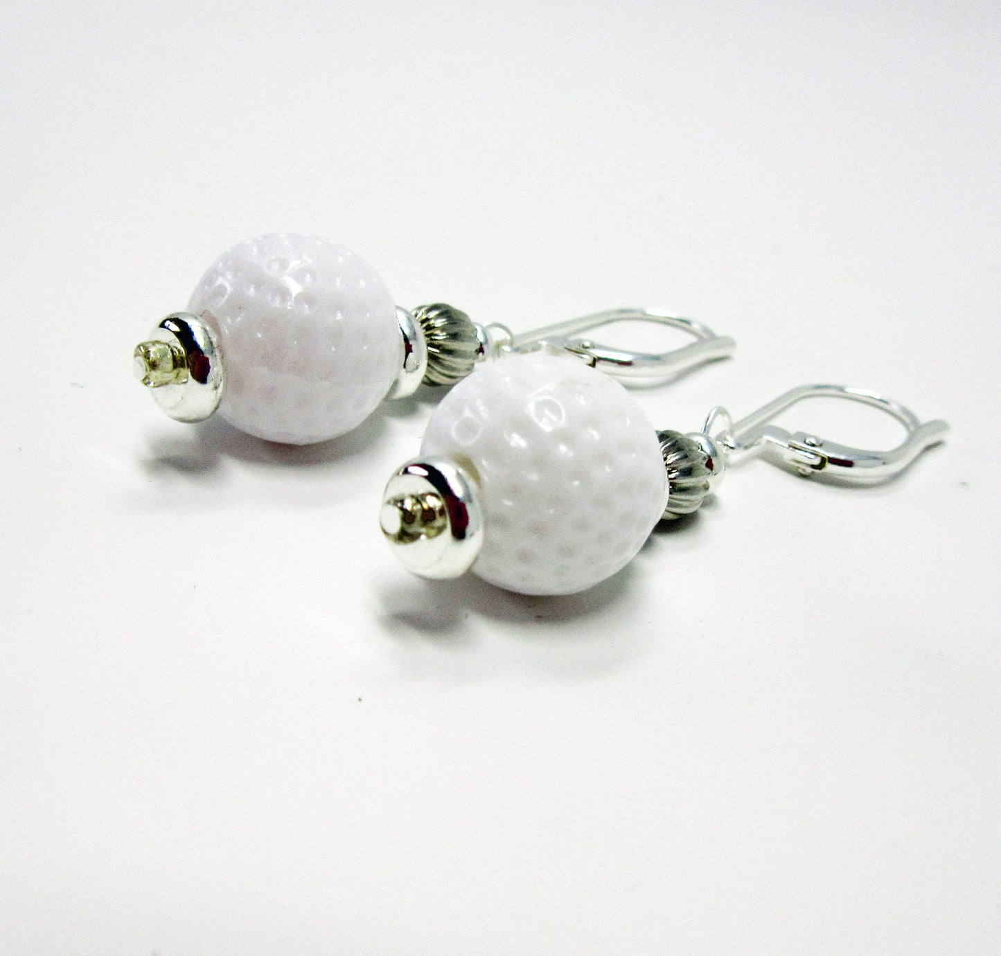 Golf Ball Lever Back Earrings: Novelty Jewelry Gift featuring white golf ball-textured beads with silver accents and secure hooks—an ideal accessory for golf jewelry enthusiasts.