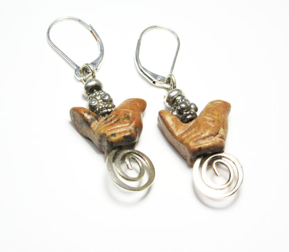 Close-up of Songbird Earrings, showcasing intricate carved stone designs ideal for spring and summer accessories.