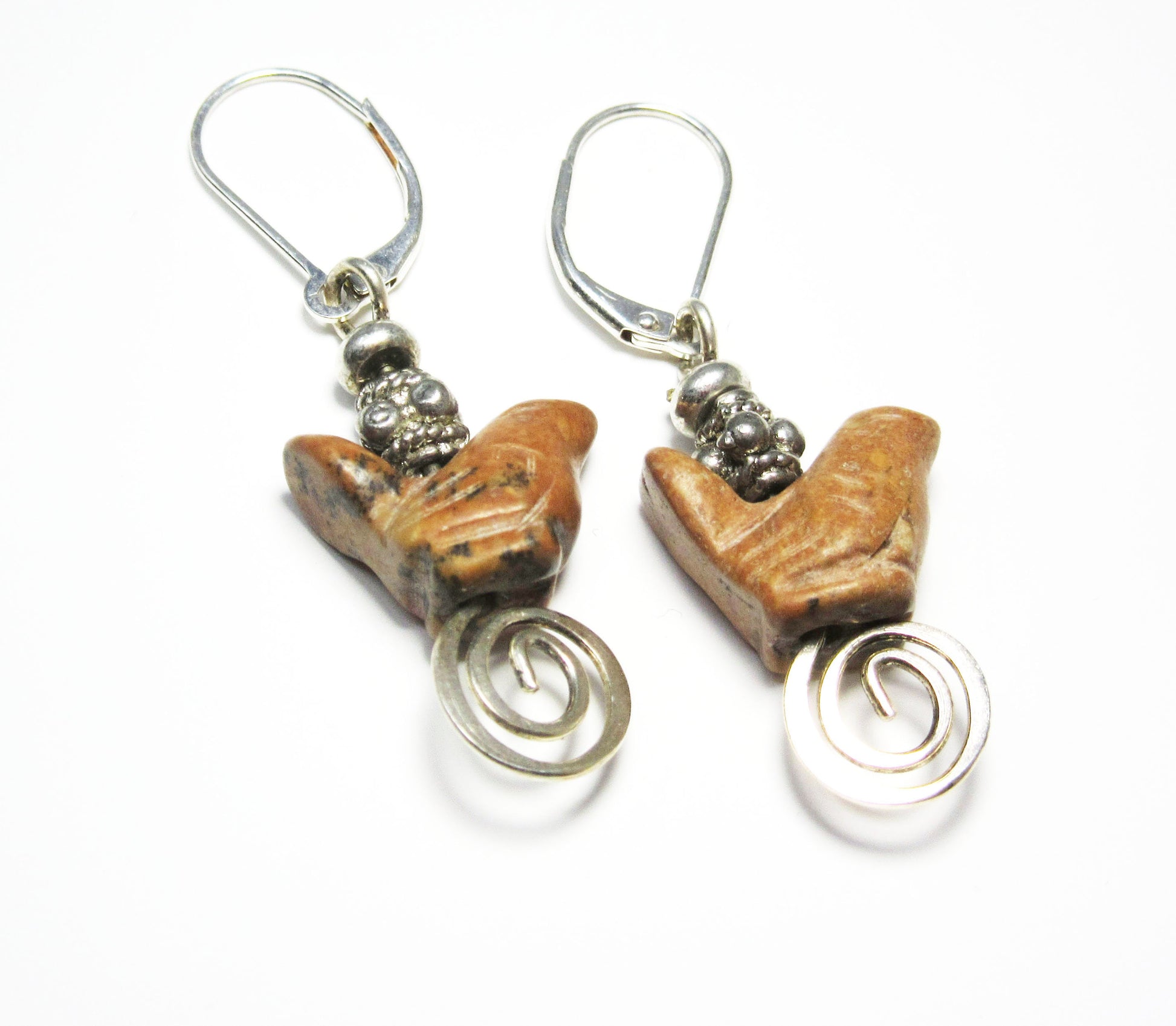 The Carved Jasper Songbird Earrings feature brown bird-shaped beads with silver accents and coiled wire dangles—an ideal handcrafted gift for bird lovers' jewelry collections. Displayed on a white background.