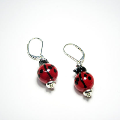Fun Earrings showcasing unique ladybug designs in lampworked glass, perfect for symbolizing good fortune and love.